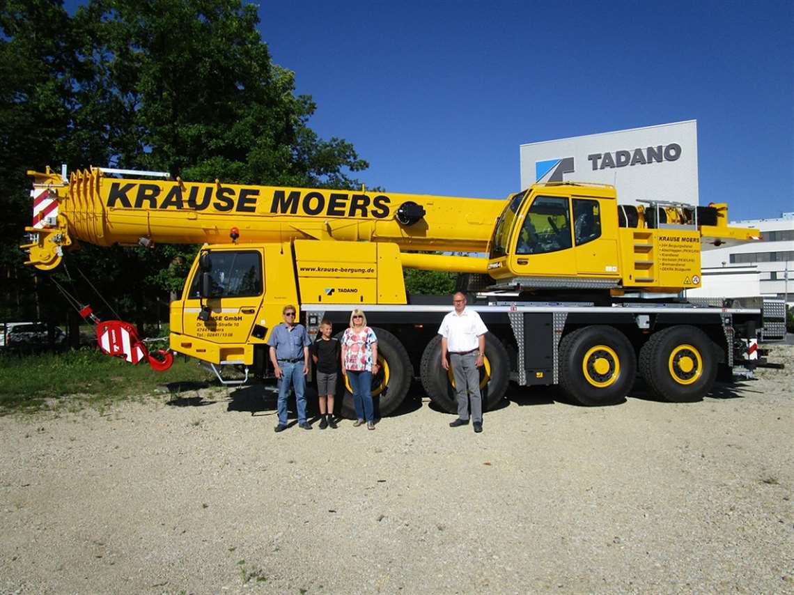 The Krause family with Tadano area sales manager Manfred Drößer, right, in front of the new Tadano ATF 100G-4. From left to right: Hans-Georg Krause, grandson Florian Güllich, and Jutta Krause