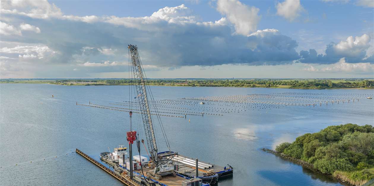 Electric Liebherr crawler crane works on dam refurbishment