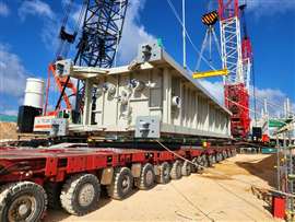 Tandem lifting with a pair of crawler cranes to offload one of the power station components from SPMT prior to upending and installation on its foundation