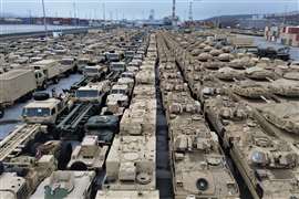 tanks and similar lined up nose to tail awaiting transport