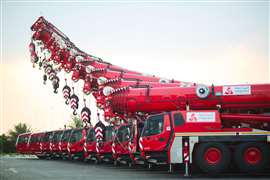 red cranes in Integrated Logistics livery lined up side by side