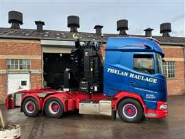 Blue and red Daf tractor with big Hiab crane behind the cab