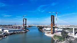 red and white Liebherr 420 EC-H 16 Litronic tower cranes on the Puente Quinto Centenario in Seville, Spain