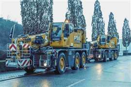 pair of yellow Tadano City cranes in the snow