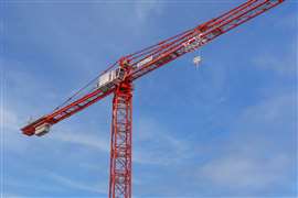 Red Wolff 8095 Compact tower crane against a blue sky