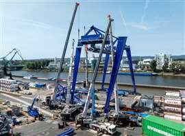 The LTM 1300-6.2 and GMK5250XL-1 repositioned to lift the leg components at the shore side end