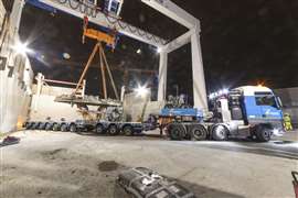 gantry crane lifting TBM bits off trailer