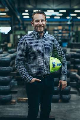 Bart Vossenberg Jr, GN Rope Fittings executive director carrying a green hard hat in the factory