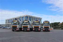A row of truck tractors in white and blue Laso Transportes colours