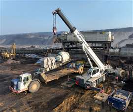 white Liebherr RT crane lifting in a mine