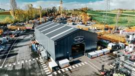 white Liebherr BESS units outside the grey Van der Spek building in Belgium