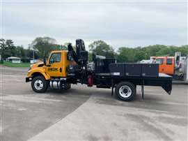Hiab loadercrane behing the orange cab of a two axle rigid truck