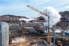 Large Liebherr self erector in front of a big steam cloud