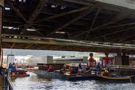 A bridge deck section is moved into position on SPMTs beneath the existing bridge structure at Amsterdam Centraal Station. Photo: Mammoet