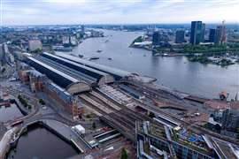 An aerial view of Amsterdam Centraal Station showing the new bridge section in place alongside ongoing construction work. Photo: Mammoet