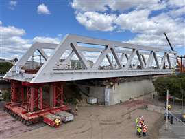 inserting more SPMT modules as the bridge makes its way off the top level