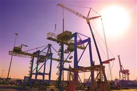 Using big wheeled mobile cranes to dismantle old STS cranes in a busy port