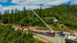 A Link-Belt RTC-80130 SII assists bridge deck construction in Placerville, California, lifting 7,500-pound shoring beams at a 90-foot radius on the north side of the structure. Photo: Link-Belt
