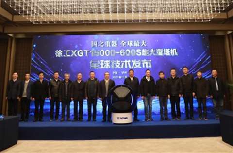 Lineup of people on stage under a banner announcing the new crane