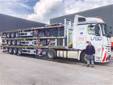 Worker stands in front of a Laso Transportes vehicle