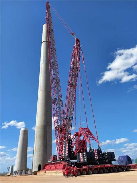 red and black Tadano crane against blue sky