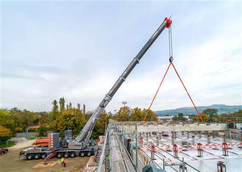 silver crane lifting long beams at shallow boom angle