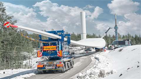 blue Scheuerle trailer carrying white turbine blade