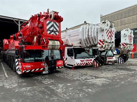 white Bay Crane and red Cranes, Inc. crane side by side