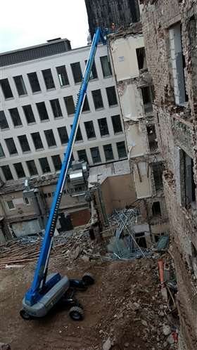Workers on site use the SX 105 XC unit to inspect the progress of the demolition