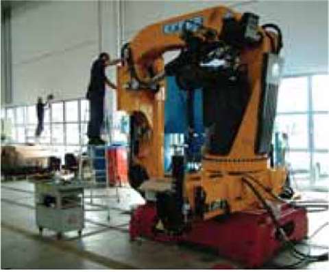 An Effer employee at work on a model 535 knuckle boom at the company's new Minerbio factory