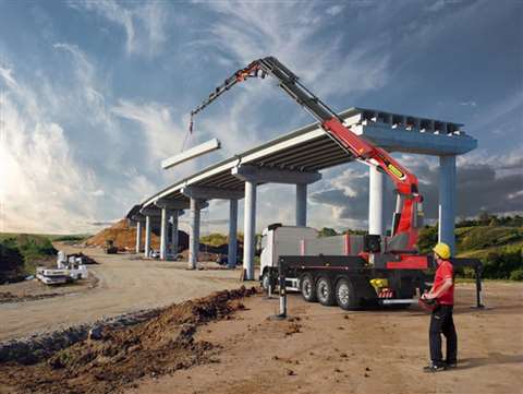 Palfinger articulating crane on a truck lifting at an elevated concrete roadway