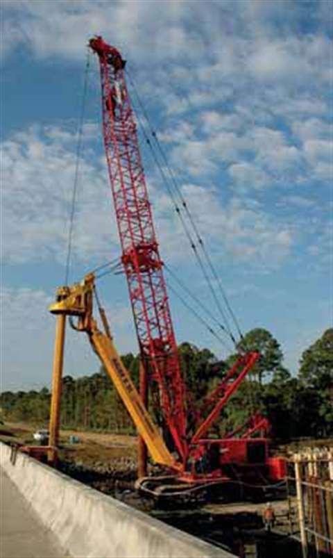 A barge-mounted Manitowoc Model 1015 is drilling shaft foundations in Georgia