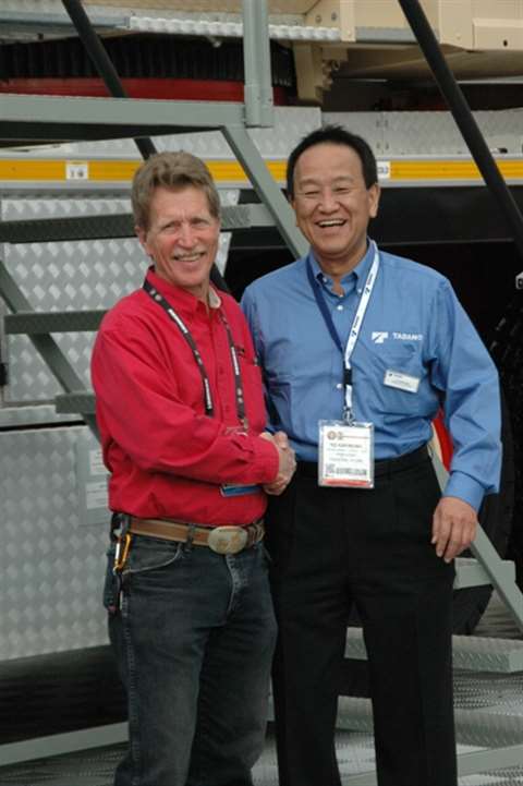 Tadano America President Yo Kakinuma (right) congratulates Harry Baker, president of Southwest Indus