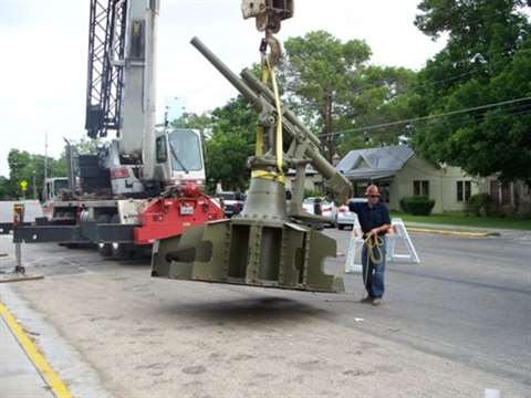 An artillery gun being lifted by a Link-Belt truck crane