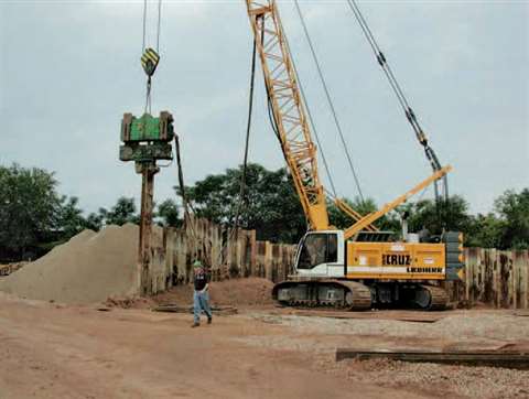 Auxiliary hydraulic lines from the vibratory hammer are plumbed into the front of the machine