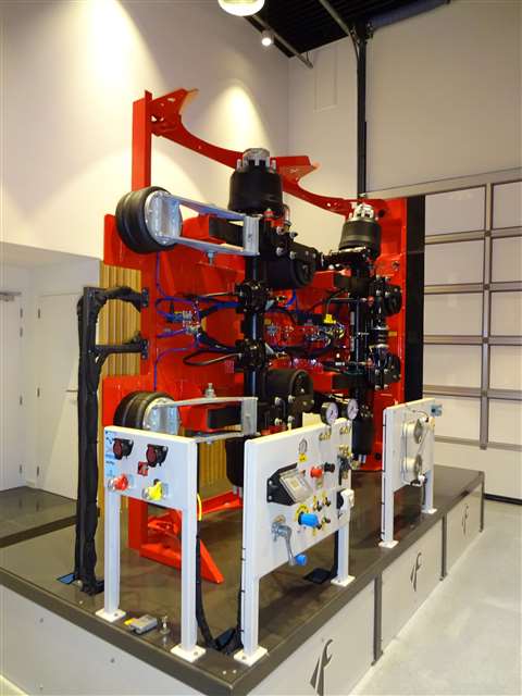 Part of the Faymonville technical training facility in Europe is an upturned red trailer standing upright on its side giving access to thecomponents for service training