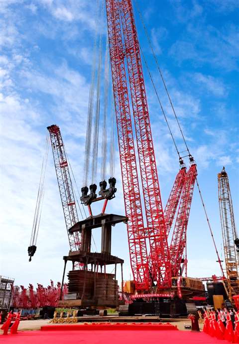 The 4,000 tonne capacity Sany SCC40000A crawler crane in red and yellow Sany colours ready for handover with red carpet and so on