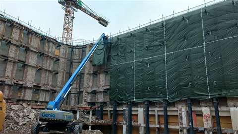 Genie SX 105XC telescopic boom lift was used to secure foil sheeting to help protect from falling debris